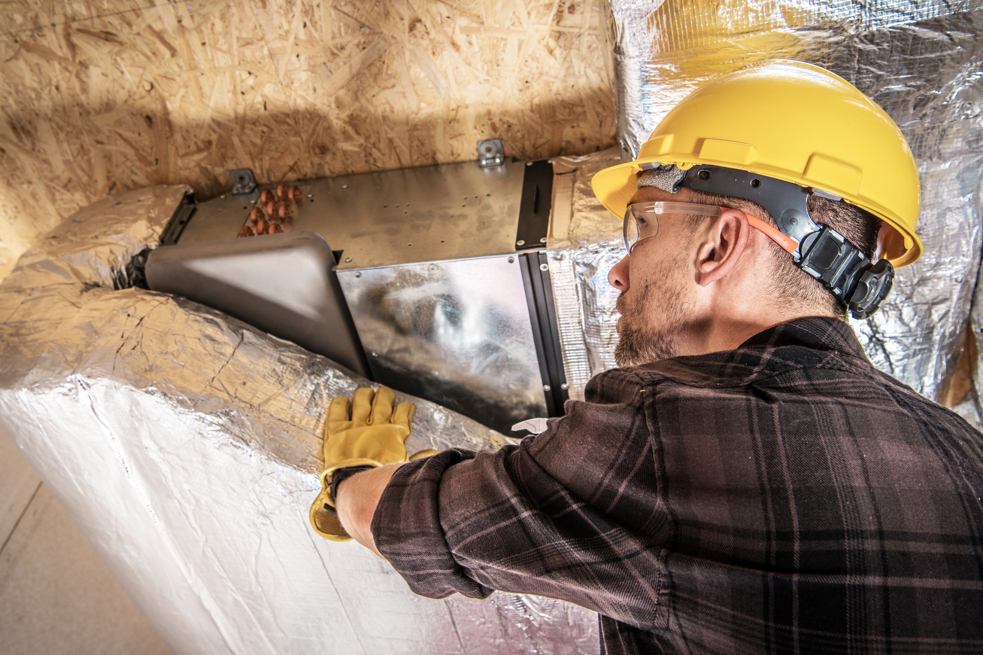 HVAC Worker Finishing Air Duct Insulation